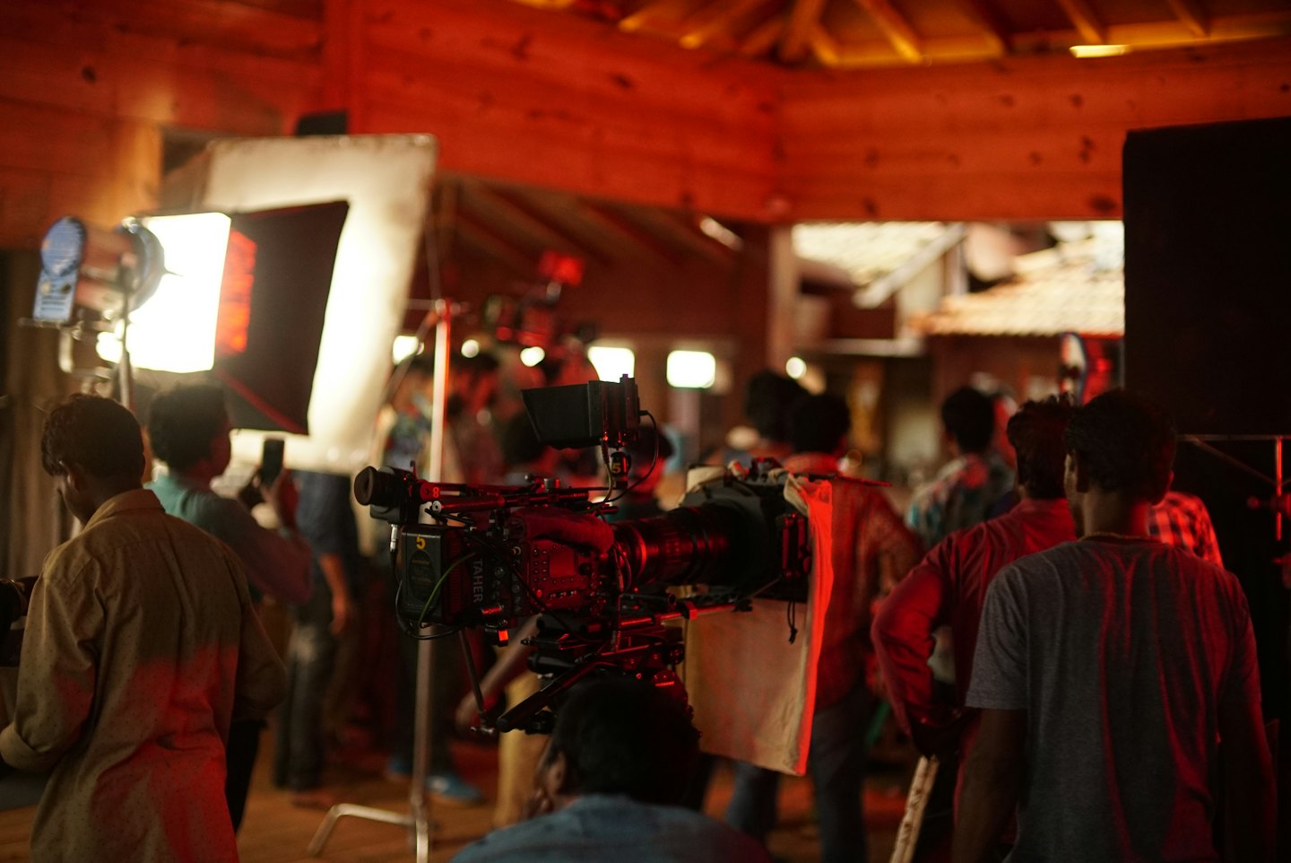 Film crew members working with a camera rig on set.