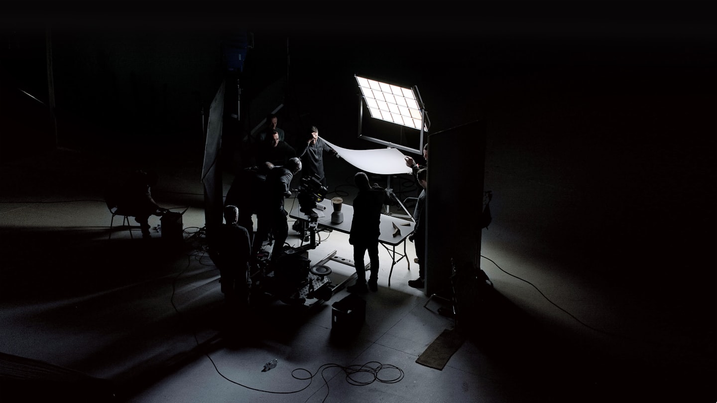 Production crew setting up a scene on a professional indoor set.